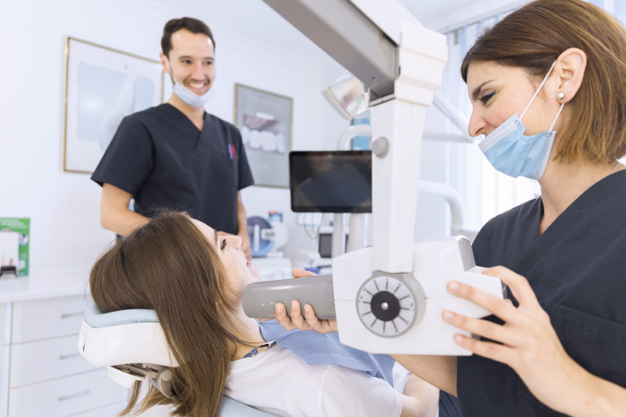 https://hairestheticdental.com/wp-content/uploads/2024/01/female-dentist-with-x-ray-machine-scanning-patient-s-teeth-dental-clinic-1280x853.jpg